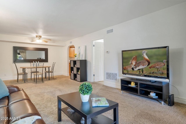 living room featuring light carpet and ceiling fan