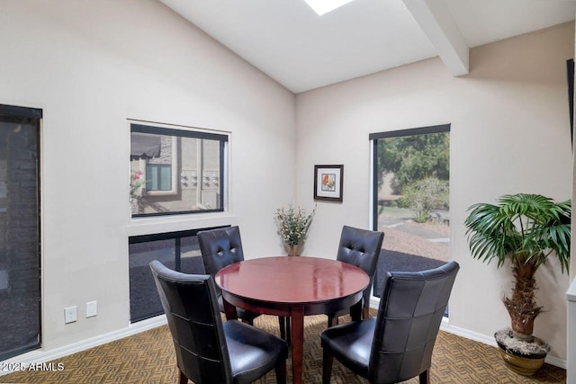 dining space featuring beam ceiling