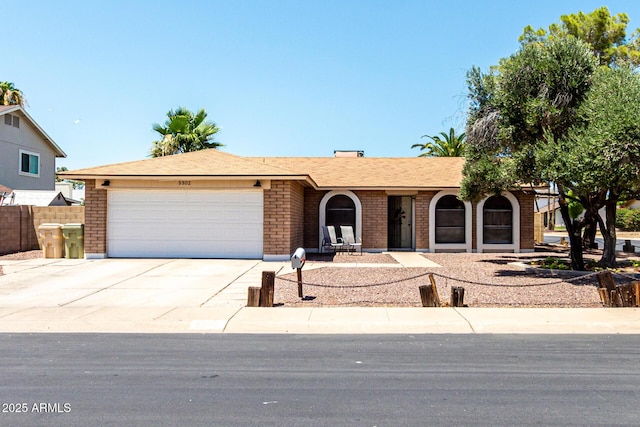 5302 W Poinsettia Dr, Glendale, AZ 85304 - ranch-style house featuring brick siding, an attached garage, and driveway