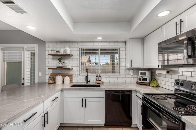 5302 W Poinsettia Dr, Glendale, AZ 85304 - kitchen featuring black appliances, tasteful backsplash, white cabinets, a tray ceiling, and open shelves