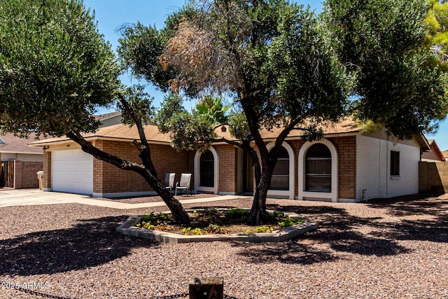 5302 W Poinsettia Dr, Glendale, AZ 85304 - view of front of house featuring brick siding, a garage, and concrete driveway