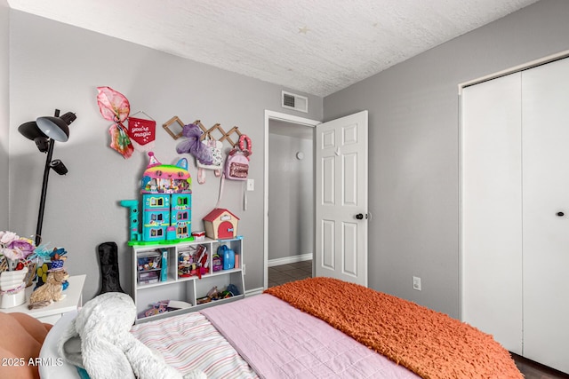 5302 W Poinsettia Dr, Glendale, AZ 85304 - tiled bedroom with a textured ceiling and a closet
