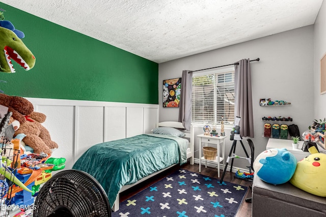 5302 W Poinsettia Dr, Glendale, AZ 85304 - bedroom with a textured ceiling, wood finished floors, and wainscoting