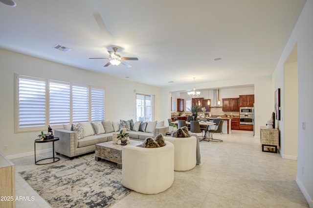 3753 E Ellis St, Mesa, AZ 85205 - living room with visible vents, baseboards, ceiling fan with notable chandelier, and light tile patterned floors