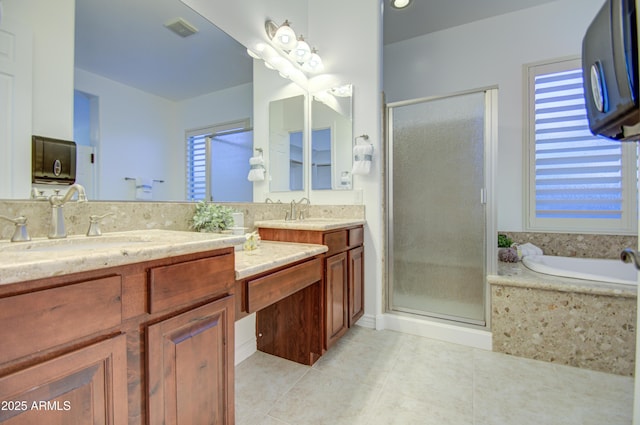 3753 E Ellis St, Mesa, AZ 85205 - full bathroom featuring double vanity, visible vents, a shower stall, a sink, and tile patterned floors