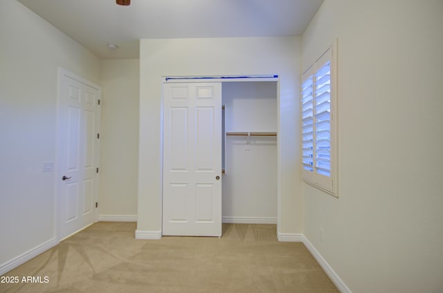 3753 E Ellis St, Mesa, AZ 85205 - unfurnished bedroom with baseboards, multiple windows, light carpet, and a closet