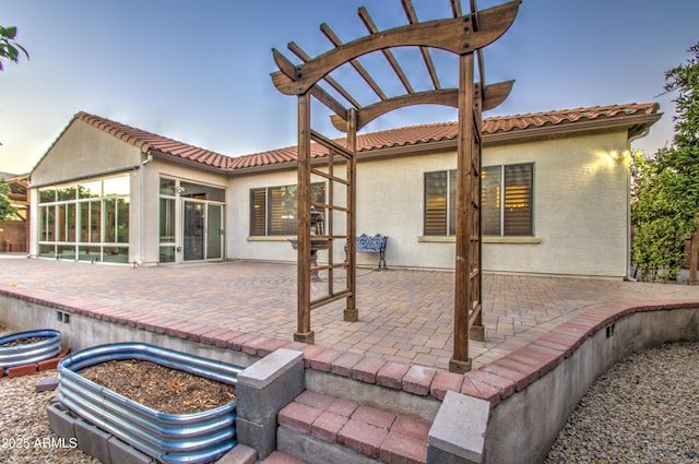 3753 E Ellis St, Mesa, AZ 85205 - back of house with a sunroom, a patio area, stucco siding, and a tile roof