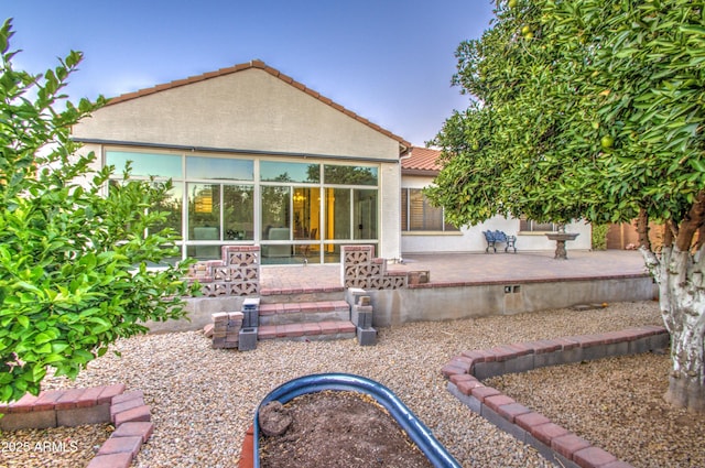 3753 E Ellis St, Mesa, AZ 85205 - rear view of house featuring a tiled roof, a patio, a sunroom, and stucco siding