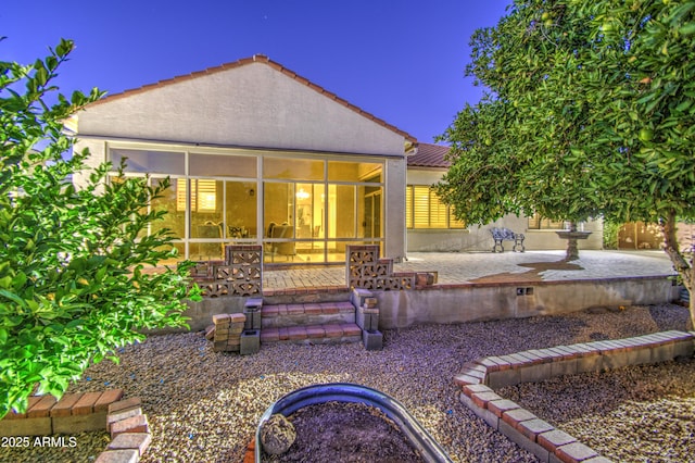 3753 E Ellis St, Mesa, AZ 85205 - back of house with a patio, stucco siding, a sunroom, and a tile roof