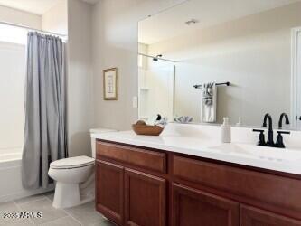 984 W Belmont Red Trl, San Tan Valley, AZ 85143 - full bathroom with vanity, toilet, shower / bath combo with shower curtain, and tile patterned floors