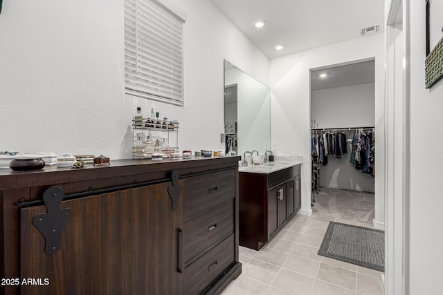 bathroom featuring visible vents, tile patterned floors, recessed lighting, vanity, and a spacious closet