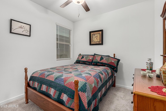 bedroom with baseboards, a ceiling fan, and light colored carpet