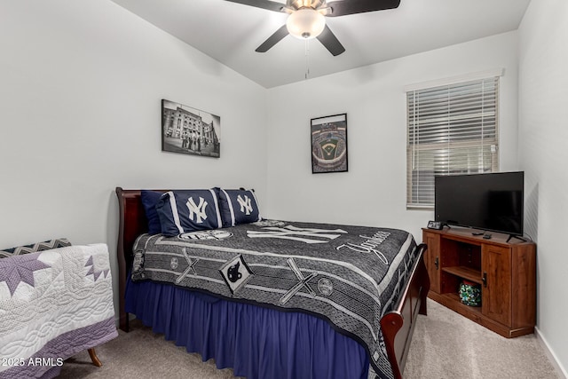 bedroom featuring baseboards, ceiling fan, and light colored carpet