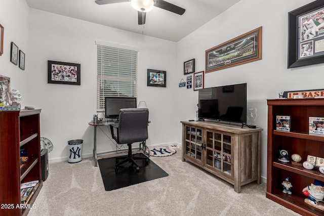 office featuring a ceiling fan, carpet floors, and baseboards