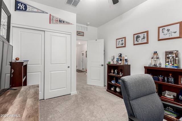 home office with ceiling fan, visible vents, and light carpet