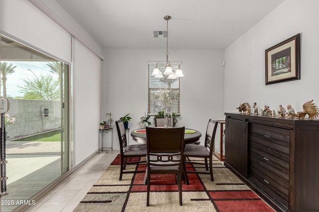 dining room featuring a notable chandelier, visible vents, and light tile patterned floors