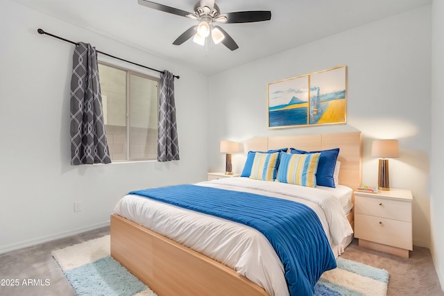 carpeted bedroom with a ceiling fan and baseboards