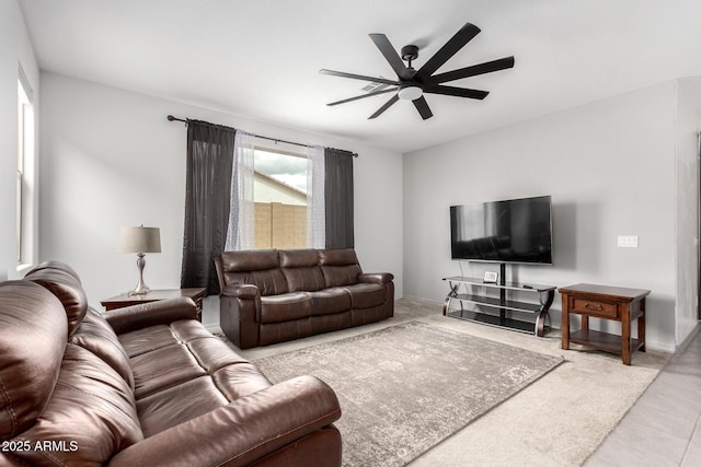 living area featuring a ceiling fan