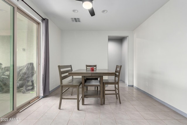 dining room with light tile patterned floors, visible vents, baseboards, and ceiling fan