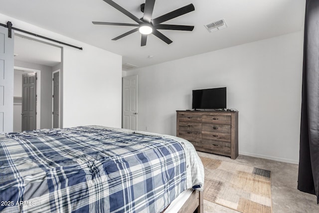 bedroom with a ceiling fan, baseboards, visible vents, light carpet, and a barn door