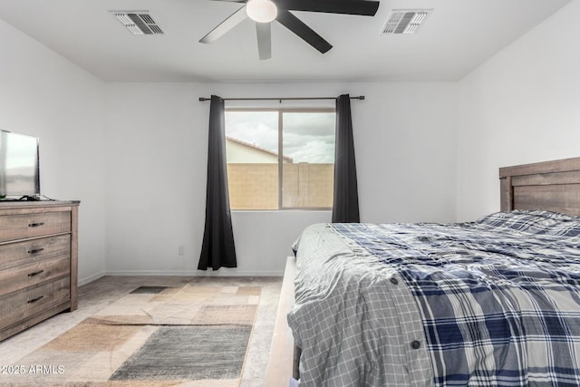 carpeted bedroom with visible vents, baseboards, and ceiling fan