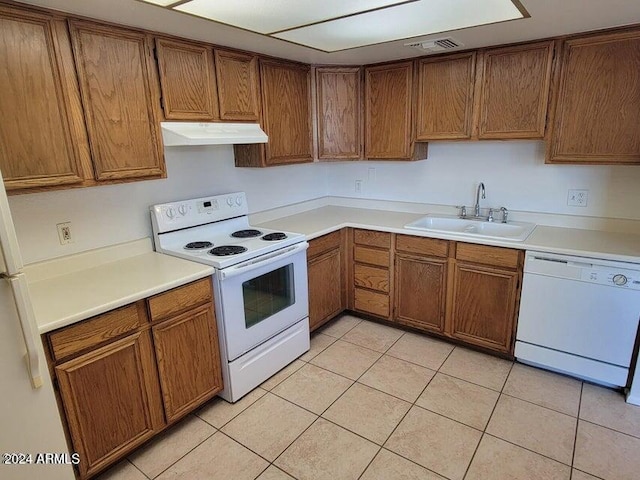 kitchen featuring sink, white appliances, and light tile patterned floors