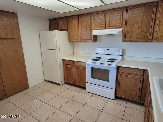 kitchen with white appliances and light tile patterned floors