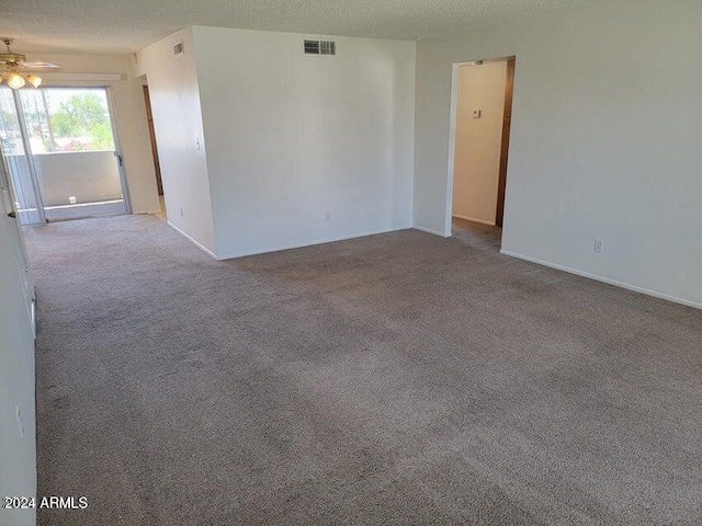 unfurnished room featuring ceiling fan, a textured ceiling, and light carpet