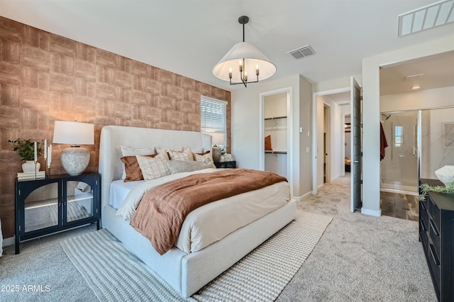 carpeted bedroom featuring a notable chandelier