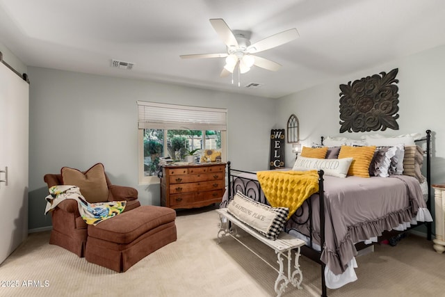 14112 W Larkspur Dr, Surprise, AZ 85379 - bedroom with light colored carpet, a ceiling fan, and a barn door