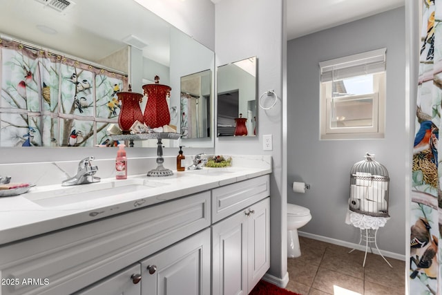 14112 W Larkspur Dr, Surprise, AZ 85379 - full bath featuring toilet, baseboards, double vanity, tile patterned floors, and a shower with shower curtain