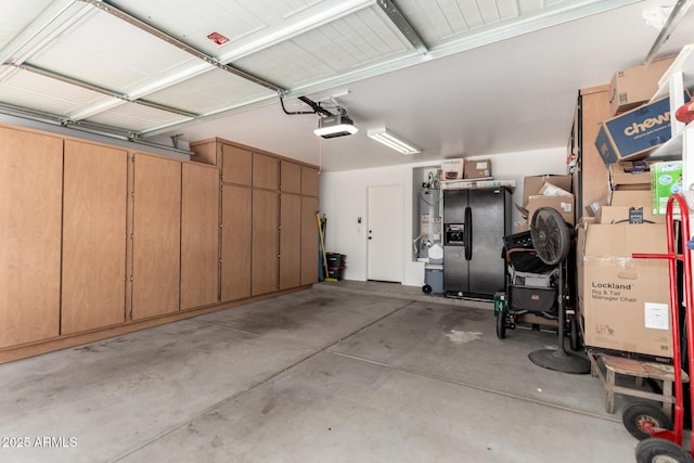 14112 W Larkspur Dr, Surprise, AZ 85379 - garage with a garage door opener, black fridge, and water heater