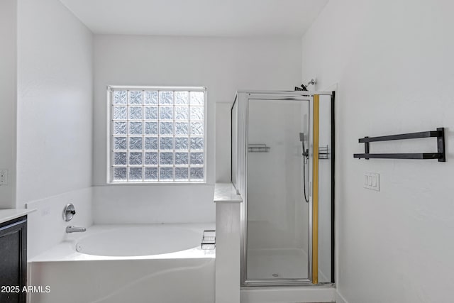 bathroom with a bath, a stall shower, and vanity