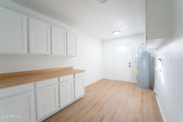 interior space featuring water heater and light hardwood / wood-style flooring