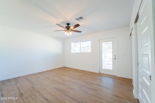 empty room with light hardwood / wood-style floors and ceiling fan