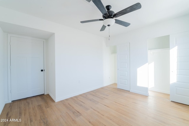 spare room with ceiling fan and light wood-type flooring