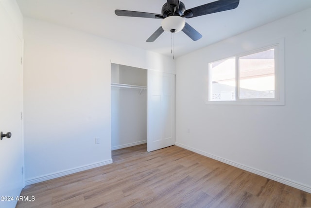 unfurnished bedroom featuring ceiling fan, a closet, and light hardwood / wood-style flooring