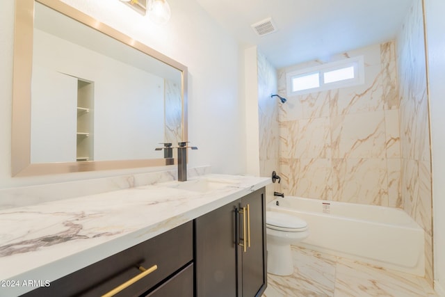 full bathroom with vanity, tiled shower / bath, and toilet