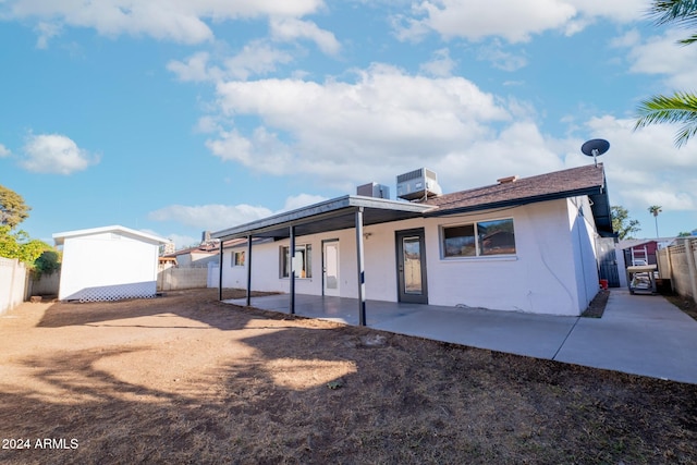 back of house featuring cooling unit and a patio