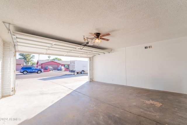 garage featuring a garage door opener and ceiling fan