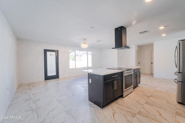 kitchen featuring wall chimney range hood, appliances with stainless steel finishes, light stone countertops, and a center island