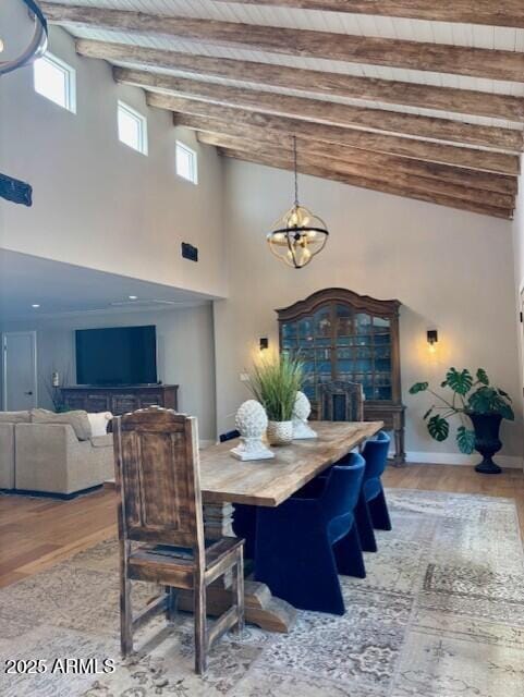 dining room featuring beamed ceiling, hardwood / wood-style flooring, and wood ceiling