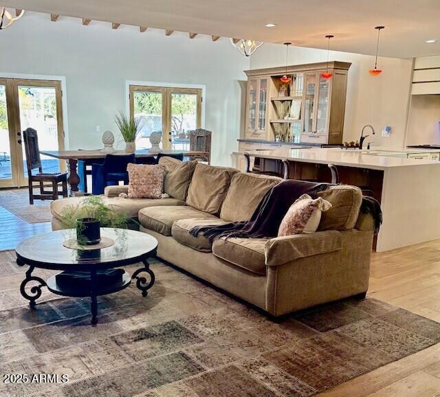 living room with french doors, a healthy amount of sunlight, and wood-type flooring