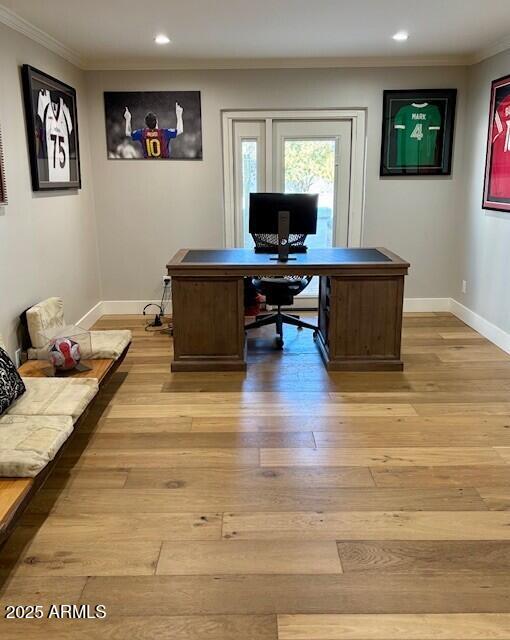 office with crown molding and light hardwood / wood-style floors