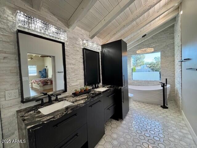 bathroom with vanity, vaulted ceiling with beams, wood ceiling, and a tub to relax in