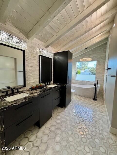 bathroom with lofted ceiling with beams, vanity, wood ceiling, and a tub to relax in