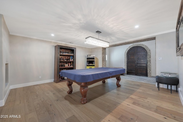 game room featuring ornamental molding, pool table, and light hardwood / wood-style floors