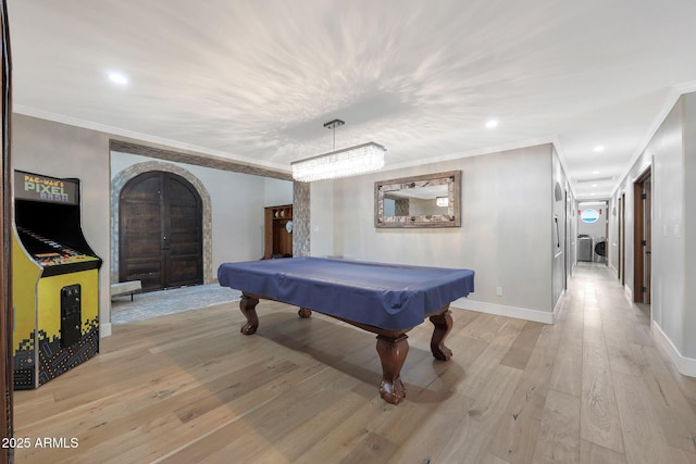 game room with billiards, ornamental molding, and light hardwood / wood-style floors