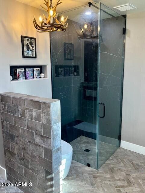 bathroom featuring parquet floors and a shower with shower door