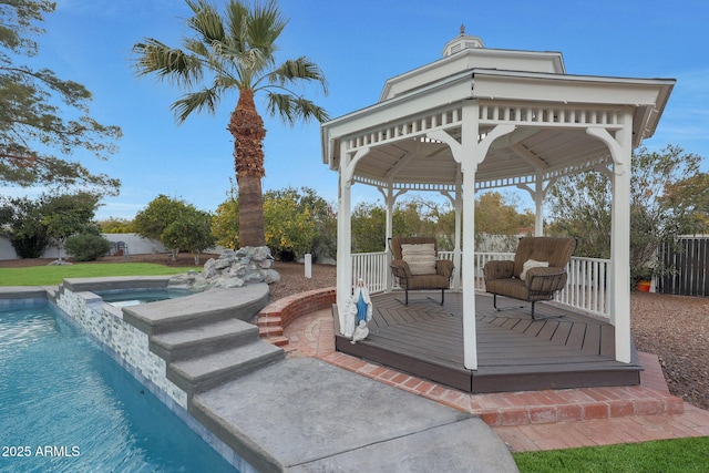 wooden deck featuring a gazebo and an in ground hot tub